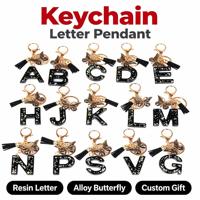 Porte-clés 3D en caoutchouc souple/PVC avec initiale alphabet noire mignonne, pendentif papillon à pompon, pour femmes, filles, cadeaux, sac à main