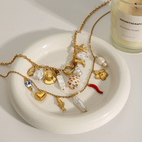 Collier Océanique Mirawell Tendance en Acier Inoxydable Plaqué Or PVD 18K avec Breloques en Céramique Corail, Étoile de Mer, Conque, Escargot, Poisson et Coquillage Perlé