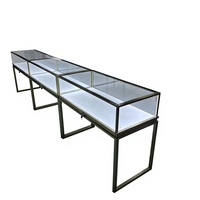 Vitrine à bijoux autoportante en verre avec cadre noir, pieds hauts et éclairage LED pour les bijouteries professionnelles