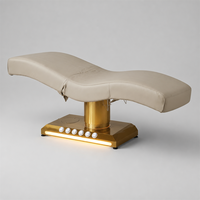 Table de soin électrique à 3 moteurs, design monobloc, colonne dorée brossée, base LED, personnalisable pour salon, spa, traitement facial, clinique
