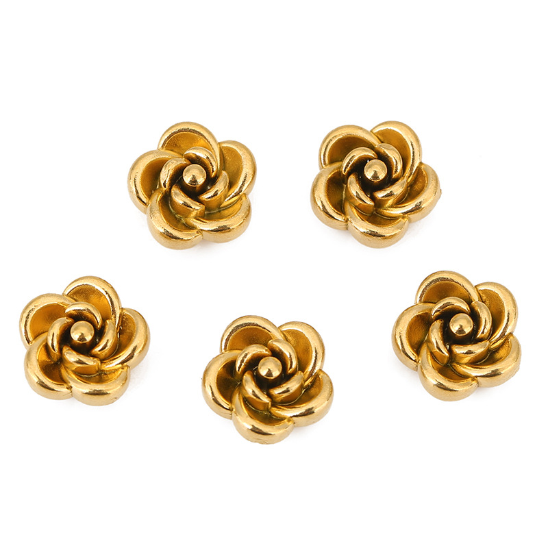 Cuentas perforadas de rosa dorada.