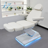 Lit de beauté ergonomique réglable de luxe avec système hydraulique électrique et lit de massage incurvé personnalisé pour salon professionnel