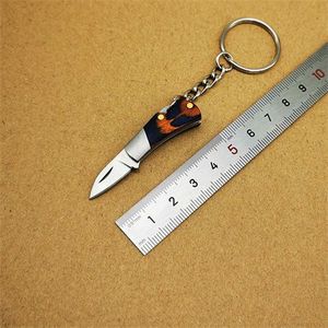 Desembalaje <span class=keywords><strong>Express</strong></span> Camping cuchillo llavero de bolsillo afilado de mano de acero inoxidable borde dentado plegable colgante de bolsillo de madera - Product Image 3