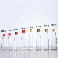 Bouteille cylindrique en verre transparent en gros avec bec verseur en plastique pour l'emballage d'huile d'olive, de vinaigre, de sauces et d'assaisonnements