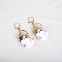 Porte-clés en peluche au crochet fait main, motif chien et fleur, pendentif tricoté avec clochette, ornement de sac en laine douce, cadeau portable et durable