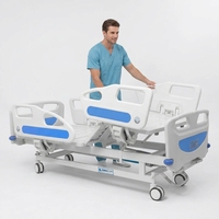 Lit d'hôpital manuel réglable avec barrière en acier laminé à froid et roues pivotantes pour soins infirmiers à domicile