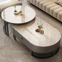 Ensemble de tables basses modernes rondes et ovales imbriquées avec tiroir de rangement, plateau en pierre frittée et structure métallique pour l'ameublement de la maison