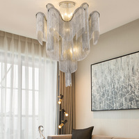 Lobby d'hôtel grand projet luxe grandes lumières art nordique artisanat métal aluminium chaîne lustre suspension