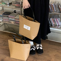 Sac de courses en papier kraft classique pour magasin de vêtements pour enfants, design simple, poignée personnalisable, vente en gros