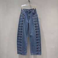 Le nouveau style d'automne américain : jeans à boutons côtelés en métal vieilli, coupe ample et courbée, pantalons à jambes larges et pantalons longs.