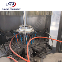 Machine de remplissage d'eau pure d'occasion, 12 têtes de remplissage, précision de remplissage de 99 %, fonctionnement simple, économie d'énergie, prix compétitif, 4000 bph