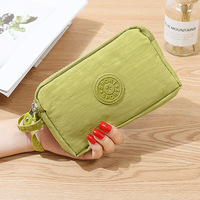 Porte-monnaie violet en nylon avec fermeture éclair pour femme, pochette à poignet pour usage quotidien, collection Printemps 2023, couleur unie, design tendance, en polyester