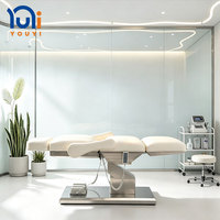 Table de beauté professionnelle électrique avec base en ABS, accoudoirs amovibles, appui-tête extensible et commande au pied