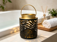 Lanterne en métal ajourée à motif de feuille noire, lanterne décorative portable en fer avec bordure dorée, option d'éclairage LED personnalisable