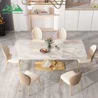 Ensemble de table à manger Wayon Luxury Gold avec plateau en pierre frittée brillante, base géométrique en métal et chaises rembourrées