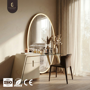 Table de toilette de luxe avec miroir ovale éclairé et structure artistique, design aux tons doux créant une ambiance intérieure chaleureuse - Product Image 1