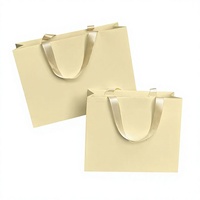 Sac cadeau en papier jaune clair, sac de transport en papier d'art, sac de shopping personnalisé avec logo pour l'emballage de vêtements et de produits de beauté