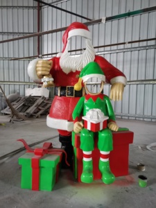 Scultura Natalizia Personalizzata in Fibra di Vetro: Babbo Natale Elfo con Scatola Regalo Forata - Product Image 2