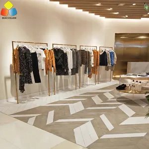 Présentoir de vêtements de vente au détail de mode Offre Spéciale Boutique de vêtements dorés conception de meubles pour magasin de vêtements