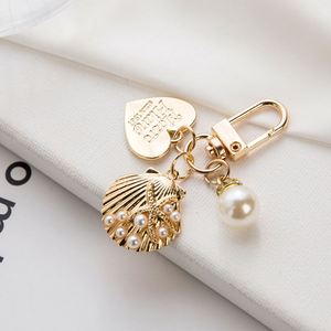 Fashion Elegant Heart Shaped <b>Shell</b> Imitation Pearl Keychain Metal Bag Pendant Gold Letter Jewelry Earphone Gift for Women - Product Image 5