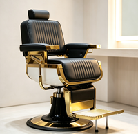 Fauteuil de barbier de luxe rétro avec cadre en métal plaqué or noir, coutures verticales, inclinable hydrauliquement