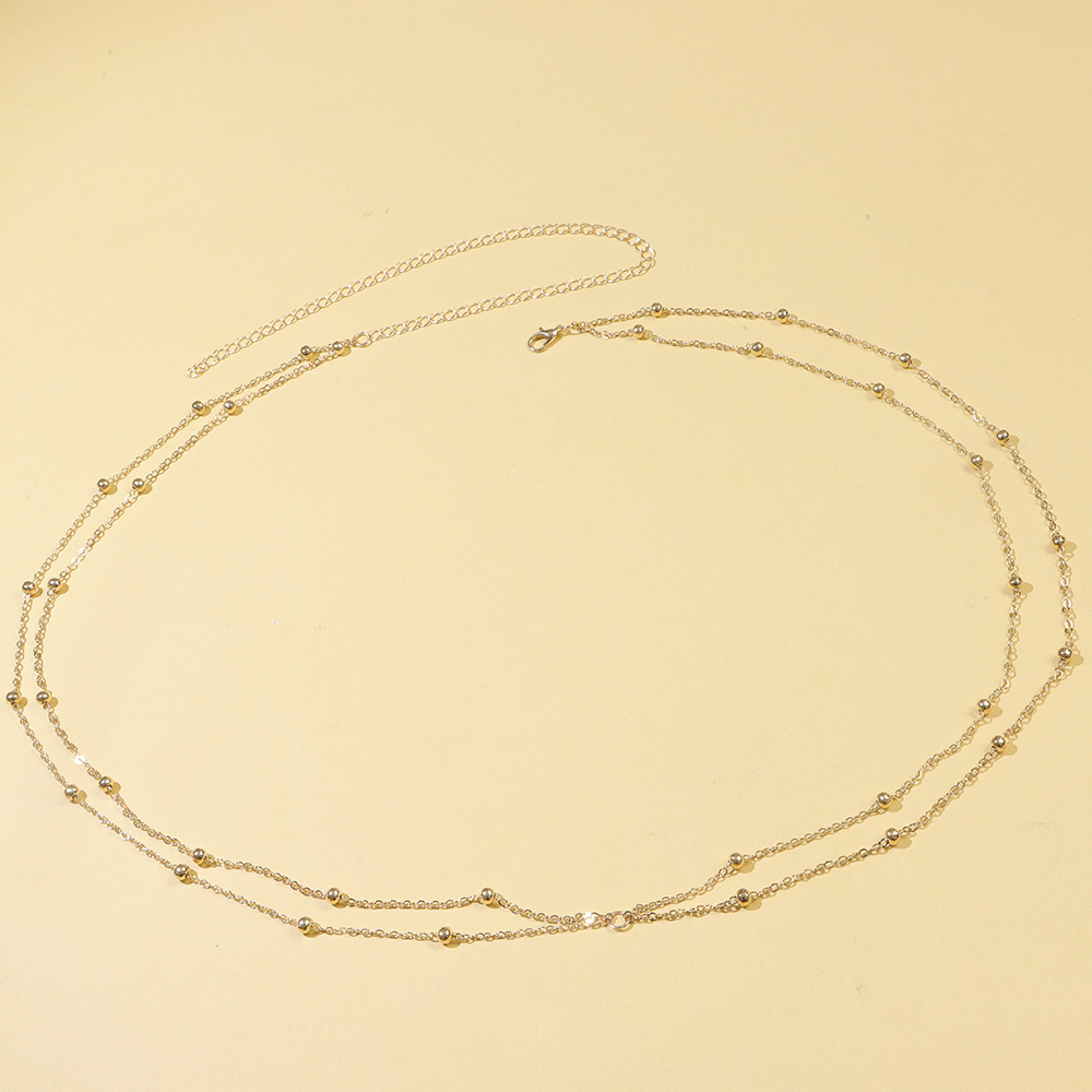 Cadena de cintura dorada de doble capa.