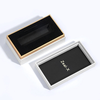 Boîte rigide de luxe 2026 blanche/noire avec manchon et accents dorés, insert en EVA pour emballage de flacons de parfum et de kits de soins de la peau