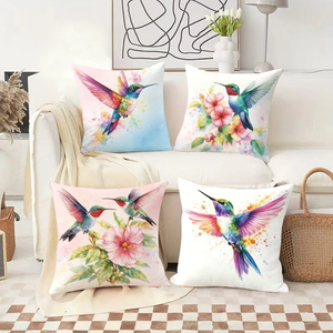 Des colibris et des fleurs aux couleurs vives ornent des coussins douillets dans un décor festif. - Product Image 2