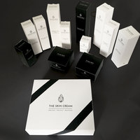 Boîtes d'emballage élégantes personnalisées d'ensemble de soins de la peau en papier carton noir et blanc pour l'emballage de produits de soin