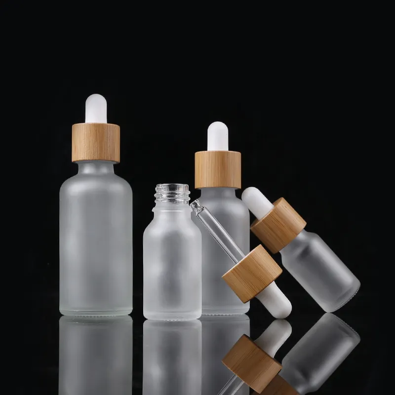प्राकृतिक कस्टम रंगीन कांच की शीशियों की बोतलें 15/30/50 मिली स्पष्ट आवश्यक तेल ठंढ बांस ढक्कन की बोतल
