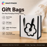 Sac en papier blanc personnalisé avec poignée en ruban noir, pelliculage mat, motif floral imprimé pour les boutiques de cadeaux et les magasins de détail