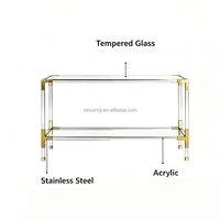 Console moderne de luxe avec plateau en verre trempé ultra-transparent, pieds en acrylique, structure en acier inoxydable brossé doré, idéale pour les couloirs étroits