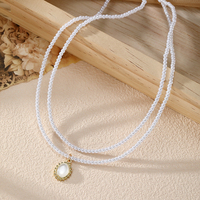 Nouveau collier de perles double couche exquis avec pendentif rond charmant, bijoux perlés polyvalents pour femmes