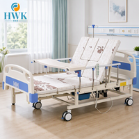 Lit d'hôpital électrique à quatre moteurs avec rotation latérale et manivelle de secours pour soins continus des patients en salle de réadaptation
