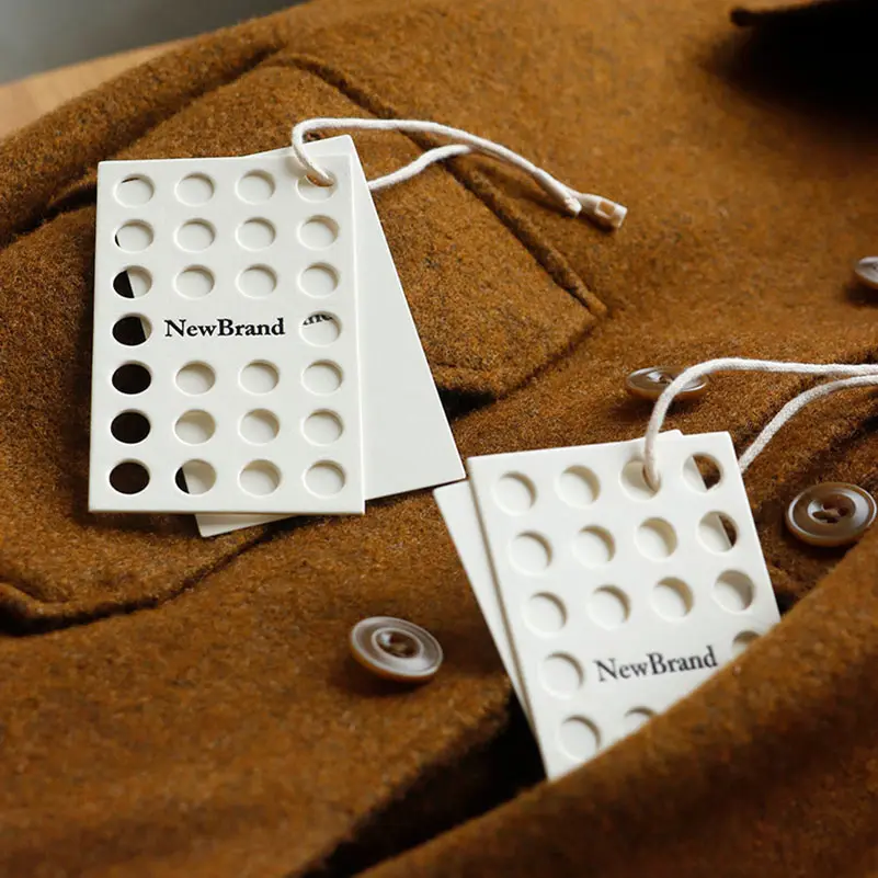ชื่อแบรนด์ Hangtags สำหรับเสื้อผ้าโลโก้ของตัวเองตัวอย่างฟรีฉลากรีไซเคิลหรูหรานูนแท็กแขวนที่กำหนดเองของขวัญกระดาษแข็ง