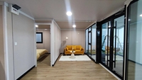 Maison conteneur en acier extensible à double aile de 20 et 40 pieds de haute qualité avec panneau sandwich au design moderne pour le camping et le bureau de chantier