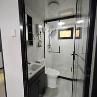 Maison modulaire préfabriquée moderne, maison préfabriquée à ossature en acier noir, maison en kit, bande lumineuse LED, mur en placage de pierre, cour arrière