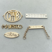 Étiquettes métalliques dorées gravées avec le logo de la marque de vêtements personnalisée en alliage de zinc Neostar pour vêtements / maillots de bain