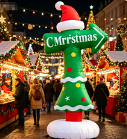 Panneau directionnel de Noël gonflable avec logo, flèche rouge et verte indiquant l'atelier du Père Noël pour la signalisation des centres commerciaux et des événements