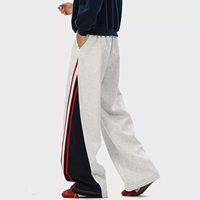 Pantalon de survêtement ample en tissu éponge avec cordon de serrage, taille élastique, patchwork, bandes latérales et blocs de couleur – Vente en gros