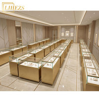 Elegante Weiß-Goldene LED-Schmuckvitrinen Freistehende Schmuck-Ausstellungsvitrine