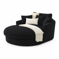 Fauteuil rond moderne en velours côtelé large noir, avec accoudoirs rembourrés, mousse haute densité et structure robuste, pour salon.