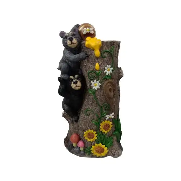 A black bear couple holds a honey bowl home decor statue on a tree stump