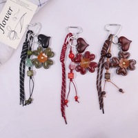 Porte-clés créatif vintage en cuir avec fleur et pompon, breloque perlée en corde tressée avec fermoir cœur métallique pour décoration de sac