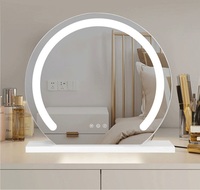 Miroir de maquillage de vanité de bureau à LED rond moderne avec un design demi-circulaire pour une utilisation en chambre