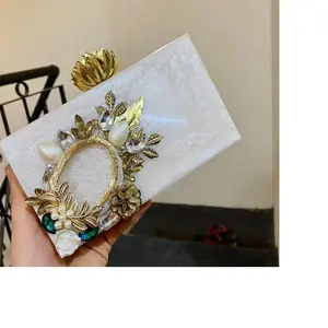 custom made resin purses in white with gold floral embellishments ideal for fashion accessory stores for resale