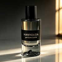 Flacon atomiseur de parfum cylindrique haut de gamme gris fumé à base épaisse, avec fond créatif en forme de montagne de glace et capuchon noir brillant, en verre personnalisé