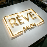 Enseigne lumineuse LED 3D d'intérieur à rétroéclairage, blanc chaud, intensité variable, avec cadre métallique doré personnalisé pour affichage mural de logo de marque en salon ou réception