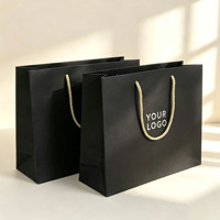 Sac shopping en papier noir mat avec logo personnalisé et poignées torsadées pour l'emballage de vêtements de boutique et de cadeaux