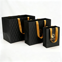 Fournisseur de sacs en papier pliables noirs personnalisés pour emballages de luxe de boutiques de mariage, de produits cosmétiques, de rouges à lèvres, de perruques et de cadeaux